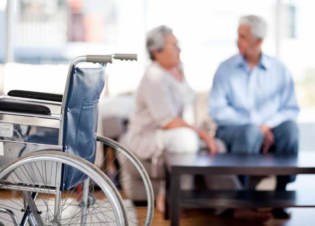 Wheelchair in front of a seated couple
