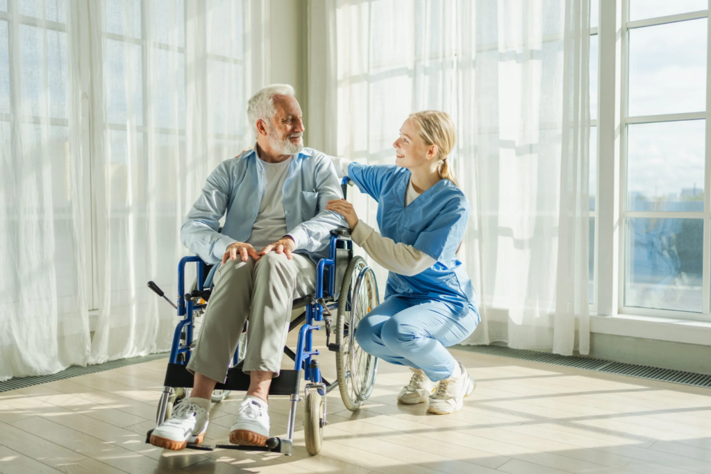 Caregiver supporting a man using a wheelchair