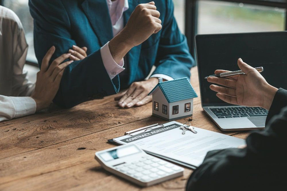 People discussing property documents with an adviser