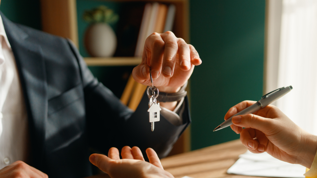 House keys being handed over above documents