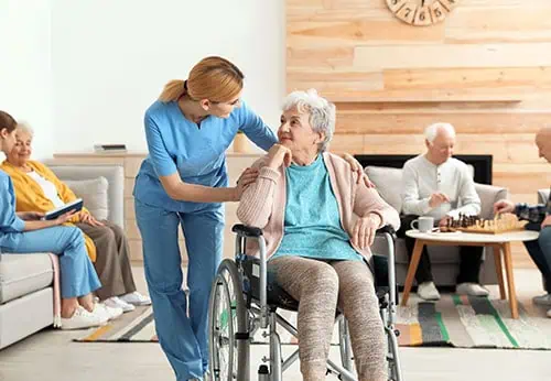 Caregiver assisting a woman in a wheelchair